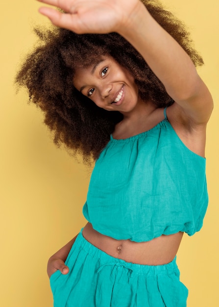 Portrait of young adorable girl posing in a cute top