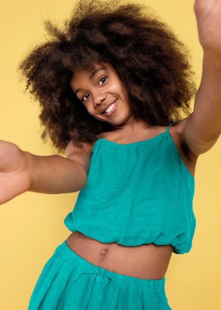 Portrait of young adorable girl posing in a cute top