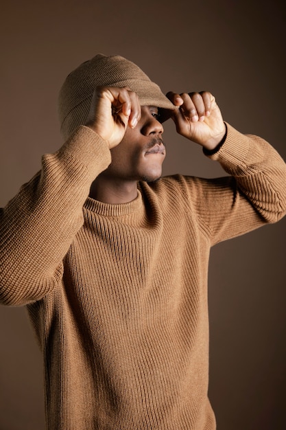 Free photo portrait young african man with cap covering eyes