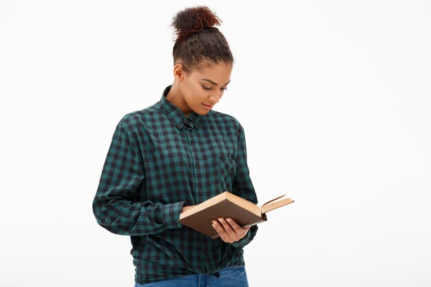 Portrait of young african woman with book on white.