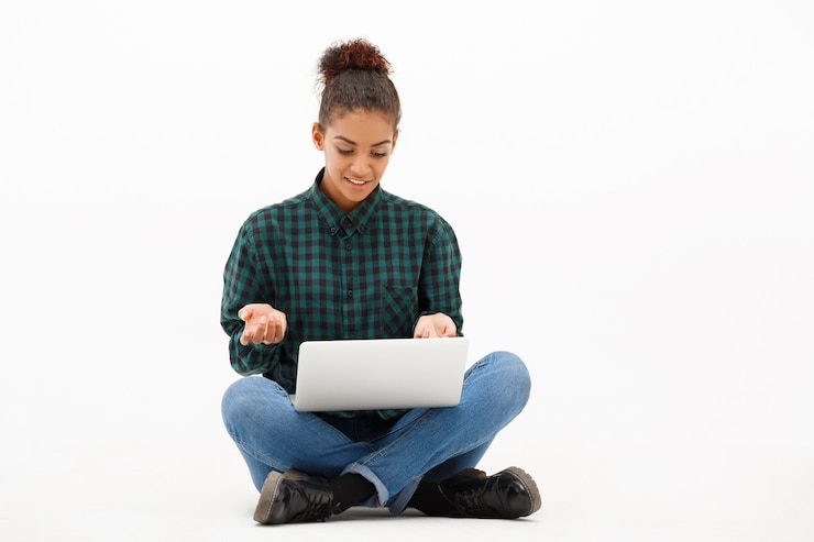 Free Photo portrait of young african woman with laptop on white