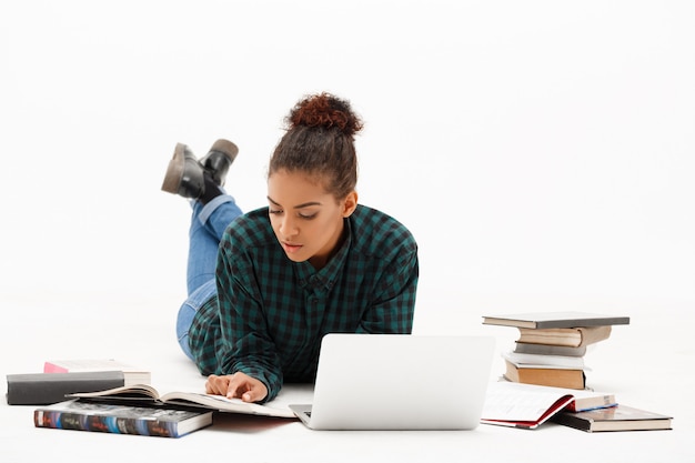 Portrait of young african woman with laptop on white