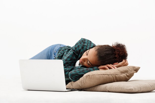 Portrait of young african woman with laptop on white