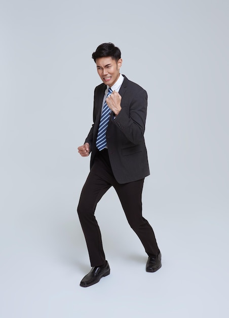 Portrait of young Asian businessman happy and success isolated on studio white background