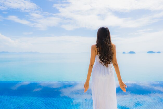 Portrait young asian woman relax smile happy around swimming pool in hotel and resort