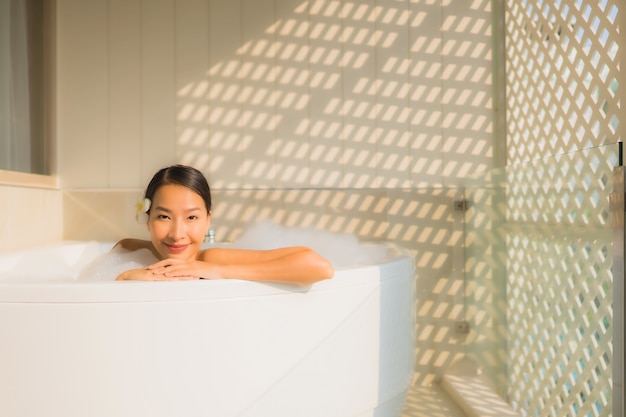 Free photo portrait young asian woman relax take a bath in bathtub