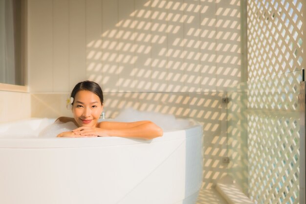 Portrait young asian woman relax take a bath in bathtub