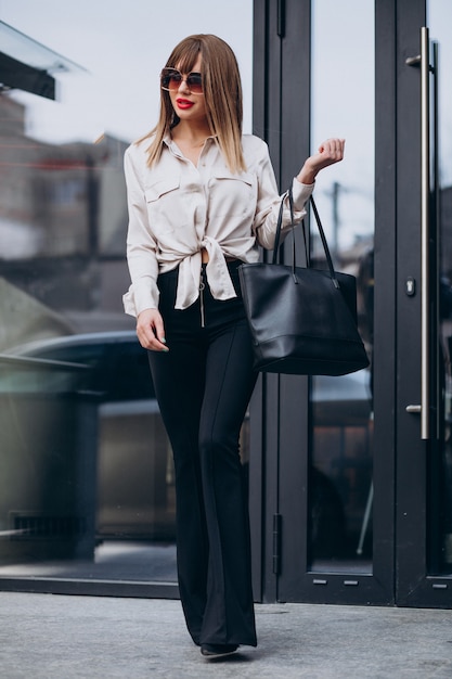 Portrait of young attractive woman model wearing balck trousers