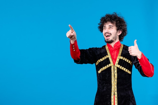 Portrait of young azeri man in traditional costume studio shot blue background spring dancer novruz