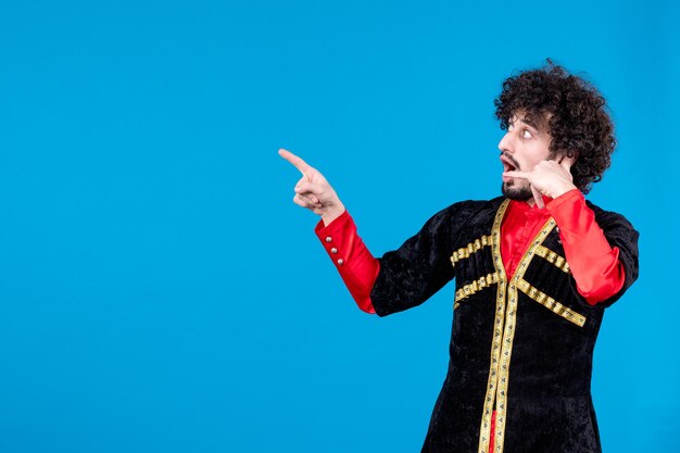 Portrait of young azeri man in traditional costume studio shot blue background spring dancers ethnic novruz