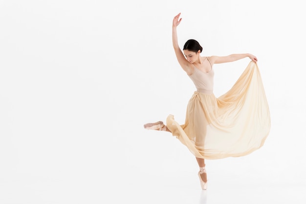 Portrait of young ballerina dancing with grace