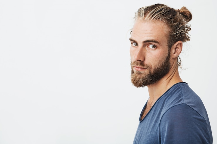 Free Photo portrait of young bearded guy with fashionable hairstyle and beard