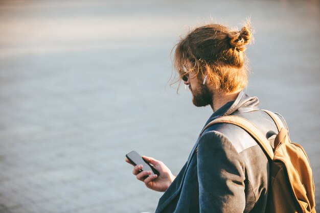 Portrait of a young bearded man in earphones