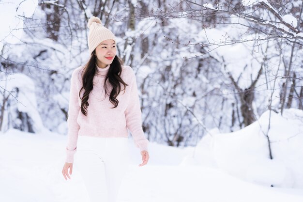 Portrait Young Beautiful asian woman smile happy travel and enjoy with snow winter season