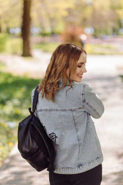 Portrait of young beautiful attractive woman at summer green park