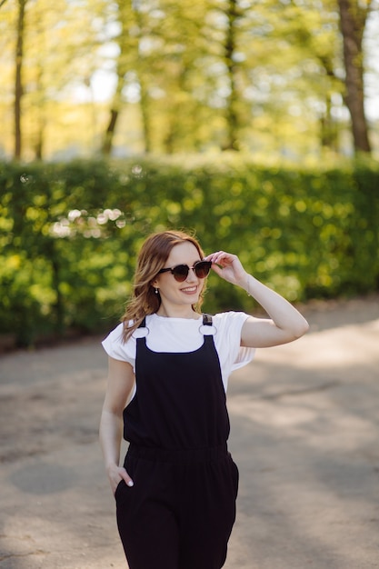 Portrait of young beautiful attractive woman at summer green park