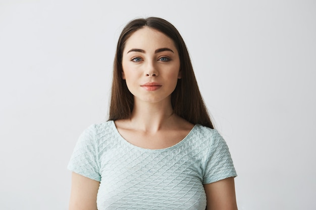 Portrait of young beautiful brunette girl smiling .