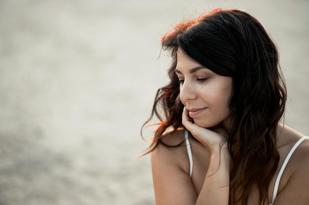 Portrait of young beautiful caucasian girl with messy hair, dreaming