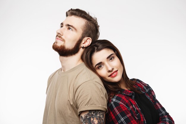 Portrait of young beautiful couple. Woman leaning man's shoulder.