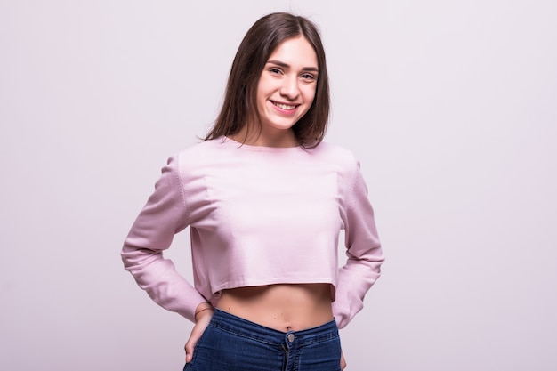 Portrait of young beautiful cute cheerful girl smiling over white background.