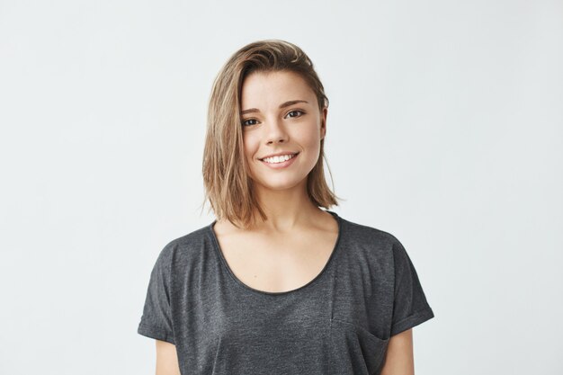 Portrait of young beautiful cute cheerful girl smiling .