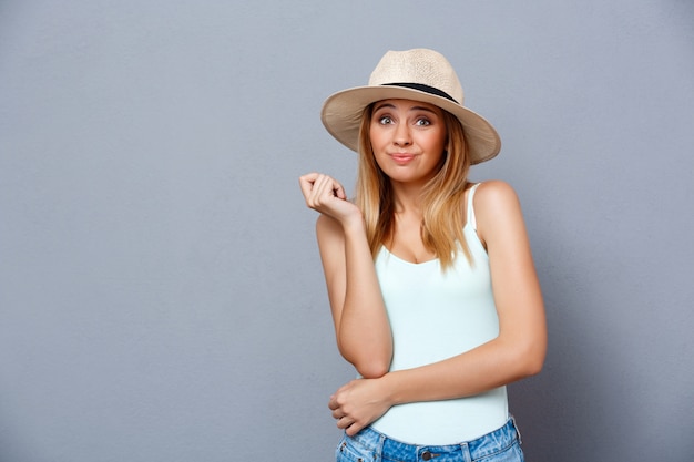 Portrait of young beautiful girl over gray background. Copy space.