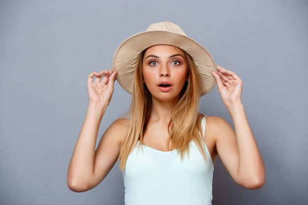 Portrait of young beautiful girl over gray background.