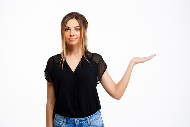 Portrait of young beautiful girl over white background. Copy space.