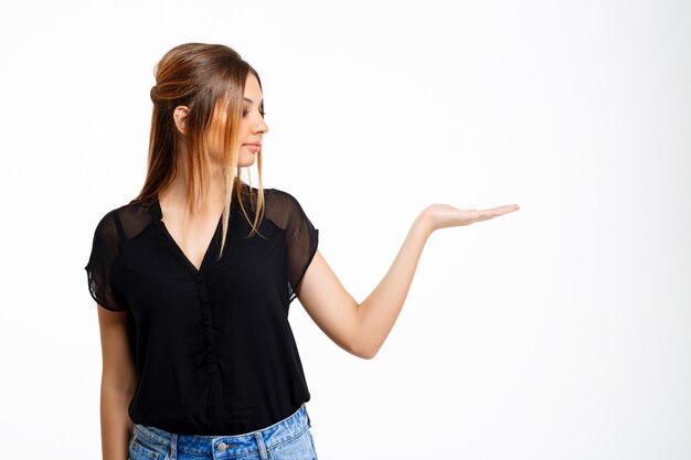 Portrait of young beautiful girl over white background. Copy space.