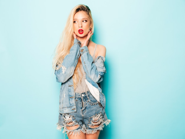 Portrait of young beautiful hipster bad girl in trendy jeans  clothes and earring in her nose.  Positive model having fun