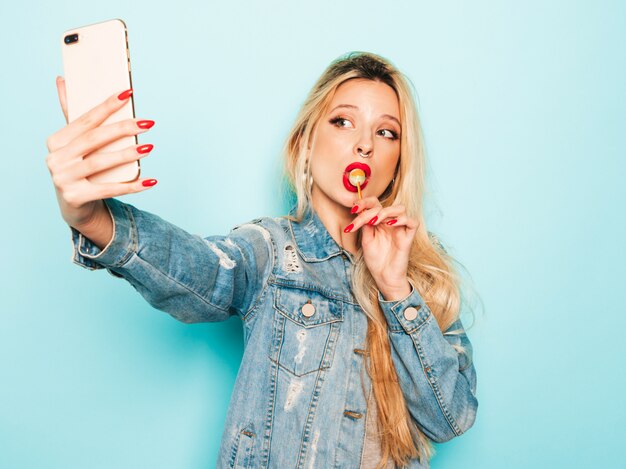 Portrait of young beautiful hipster bad girl in trendy jeans summer clothes and earring in her nose