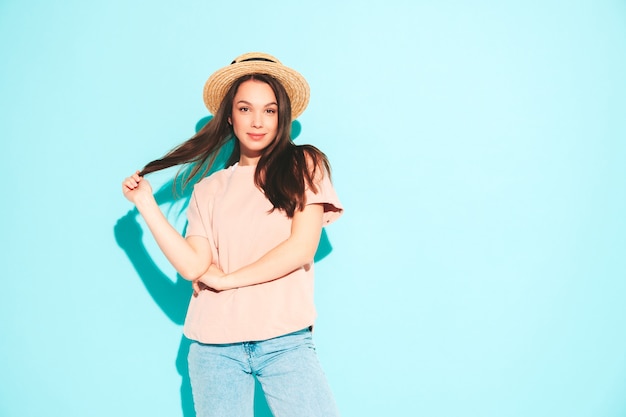 Portrait of young beautiful smiling female in trendy summer hipster clothes
