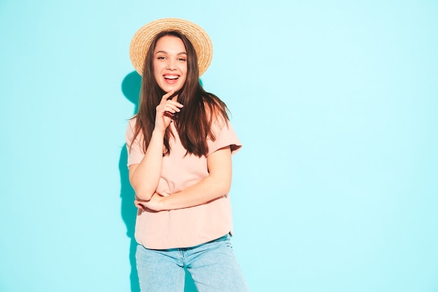Portrait of young beautiful smiling female in trendy summer hipster clothes