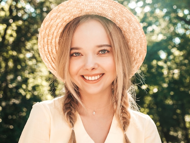 Portrait of young beautiful smiling hipster girl in trendy summer sundress