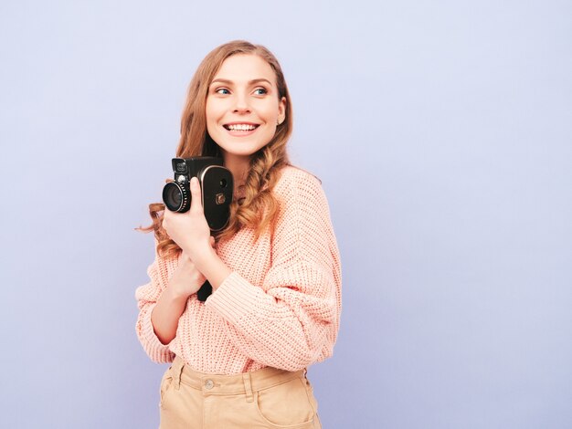 Portrait of young beautiful smiling woman in trendy summer clothes