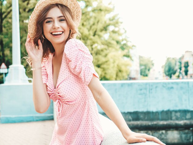 Portrait of young beautiful smiling woman in trendy summer sundress