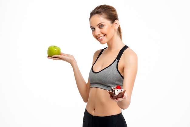 Portrait of young beautiful sportive girl over white background.