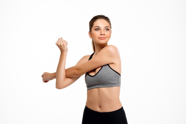 Portrait of young beautiful sportive girl over white background.