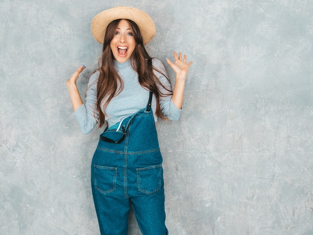 Portrait of Young beautiful surprised woman looking . Trendy girl in casual summer clothes. Shocked .Raised hands