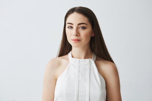 Portrait of young beautiful tender girl in blouse smiling .