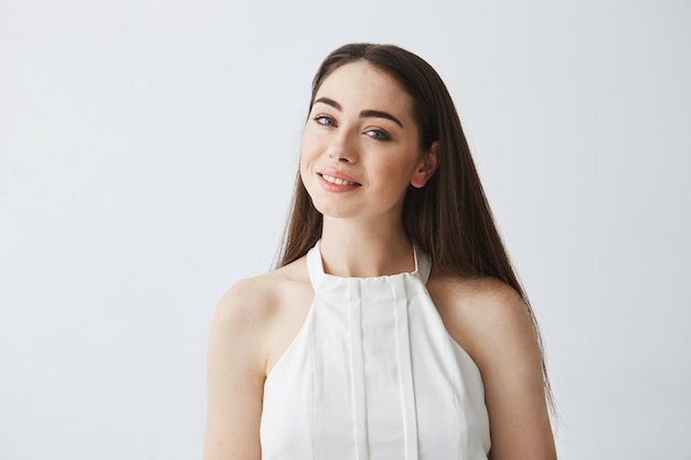 Portrait of young beautiful tender girl in blouse smiling .