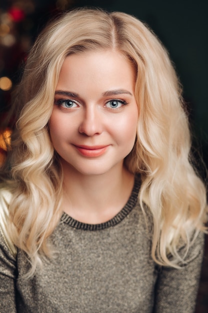 Portrait of young beautiful woman poses for the camera and smiles