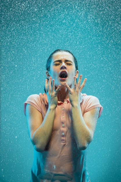 The portrait of young beautiful woman in the rain