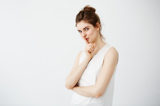 Portrait of young beautiful woman showing keep silence.