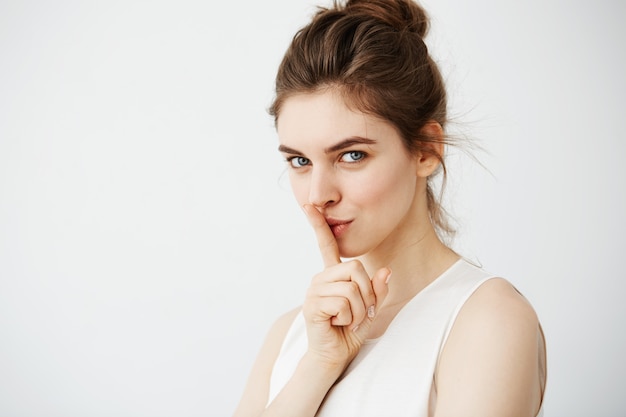 Portrait of young beautiful woman showing keep silence