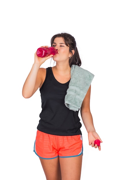 Portrait of young beautiful woman wearing sport clothes and drinking something