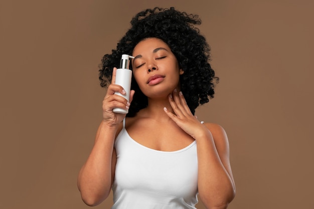 Portrait of young beautiful woman with beauty product