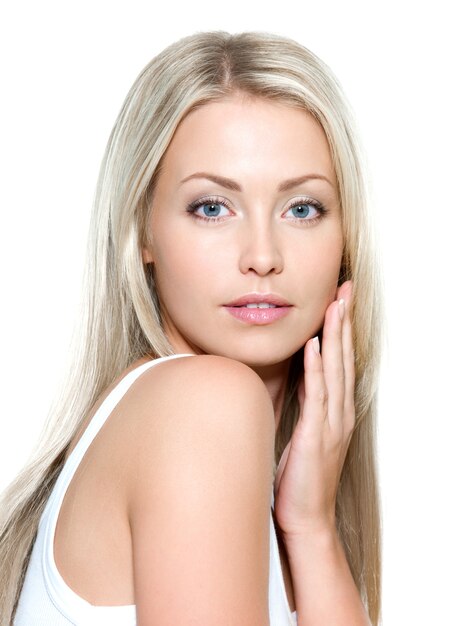 Portrait of young beautiful woman with hand on cheek - isolated