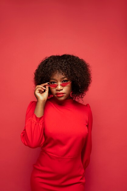 Portrait of young beautiful woman with red dress