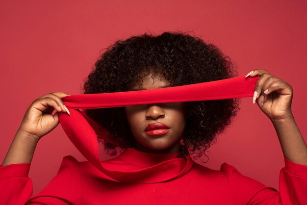 Portrait of young beautiful woman with red dress